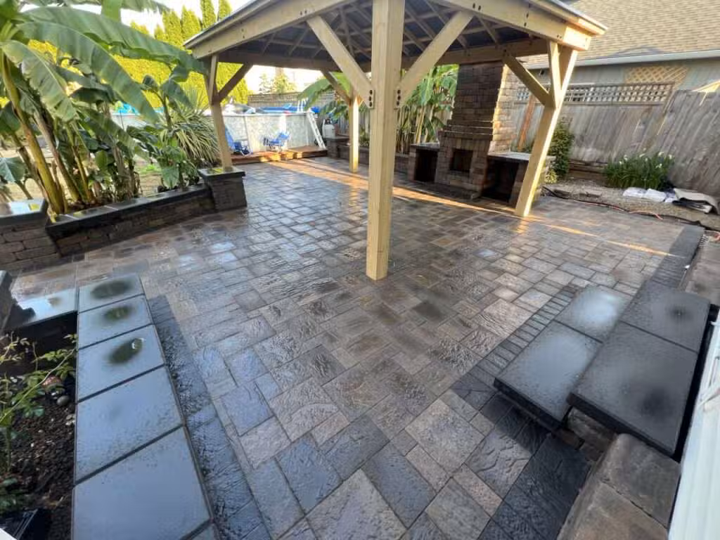 Paver patio with pergola showcasing landscaping services, hardscaping design, and outdoor construction.